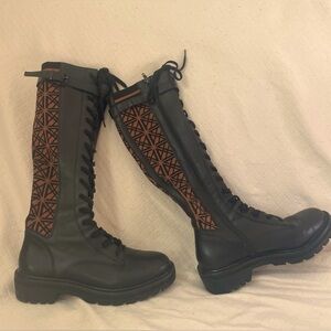 Knee high lace up black leather combat boots